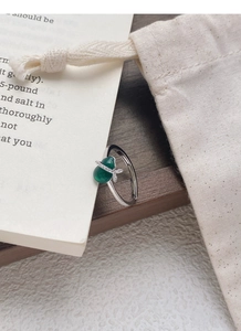 Detailed macro view of S925 sterling silver ring with green chalcedony and small diamonds