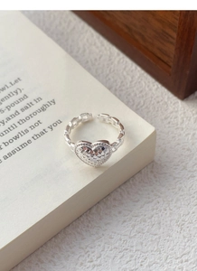 Detailed macro view of S925 sterling silver heart ring with faceted ice texture
