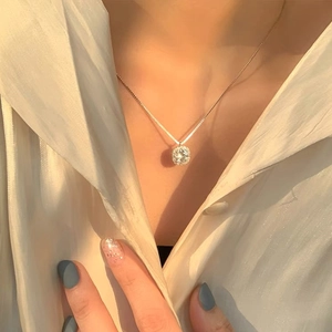 Elegant S999 silver halo necklace with round zircon on a model in warm light