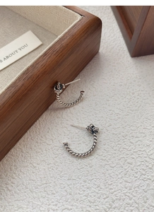 Detail view of retro S925 sterling silver twisted rope knot earrings with oxidized finish