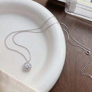 Elegant S999 sterling silver necklace with square cubic zirconia pendant on white ceramic