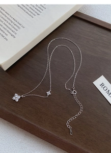 Macro detail of S999 sterling silver four-leaf clover necklace with sparkling cubic zirconia