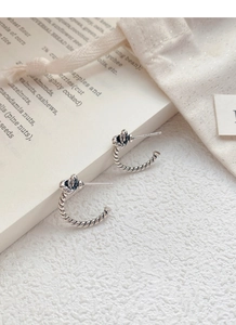 Detail shot of vintage twisted knot earrings featuring S925 sterling silver hallmark