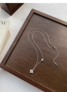 Detail of S925 silver necklace with sparkling clover charms and adjustable lobster clasp