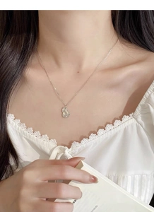 Detail of S925 sterling silver gourd necklace with crushed ice diamonds on a female model