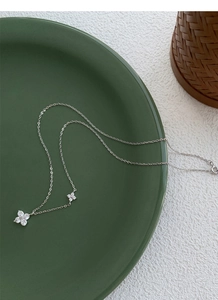Detailed view of silver S999 four-leaf clover necklaces with shimmering zircon crystals