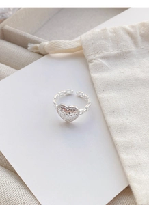 Detail of S925 sterling silver heart ring with hammered texture and chain band