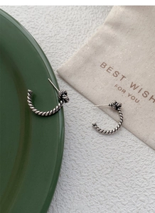 Close-up of S925 sterling silver vintage twisted rope knot earrings with oxidized finish