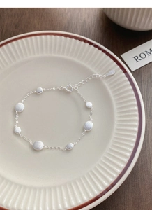 Macro detail of S925 sterling silver bracelet with matte round beads and spring clasp