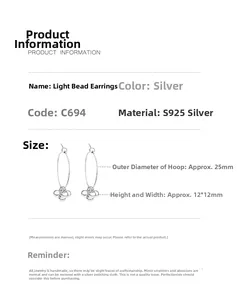 Macro shot of S925 sterling silver hoop earrings with shiny bead geometric pendants