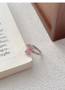 Macro shot of a light luxury S925 sterling silver ring with a large pink rectangular zircon