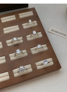 Collection of S925 sterling silver rings with various cubic zirconia cuts in a wooden tray
