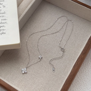 S999 sterling silver four-leaf clover necklace with cubic zirconia on a beige tray