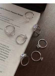 Detailed view of silver rings set with diverse sparkling cubic zirconia stone shapes