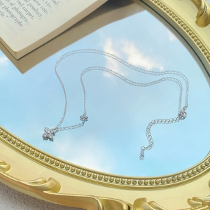 S999 sterling silver four-leaf clover necklace with sparkling crystals on mirror background