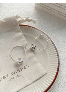 Minimalist S925 sterling silver hoop earrings with bead flower detail on a fabric gift bag