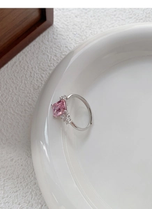 Detailed macro view of an adjustable S925 silver ring featuring a square pink zircon gemstone