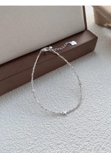Detailed close-up of S925 sterling silver star charms and delicate sparkling chain link