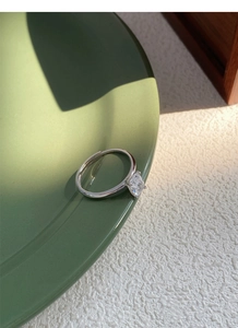 Macro shot of silver S925 ring with square-cut cubic zirconia and adjustable band detail