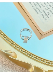 Macro shot of S925 sterling silver ring with large square cut zircon on blue mirror base