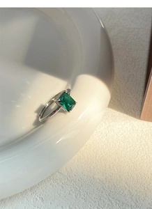 Macro shot of an adjustable S925 sterling silver ring with emerald-cut green zircon stone