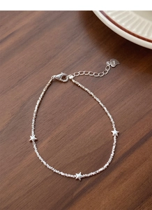 Close-up of S925 sterling silver star bracelet with irregular beads and heart tag