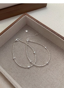 Close-up of S925 sterling silver star bracelets with faceted silver beads in a jewelry box