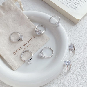Elegant S925 silver rings set with sparkling cubic zirconia on a ceramic plate