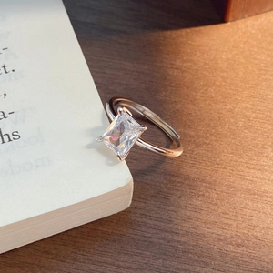 Elegant S925 sterling silver ring with large rectangular zircon on a wooden desk