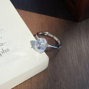 Classic S925 sterling silver ring with oval cubic zirconia on a white book page