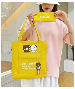 Close-up of vibrant yellow canvas tote and pouch featuring cartoon bear and rabbit prints