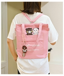 Pink canvas backpack with cartoon animals and a teddy bear charm for daily use