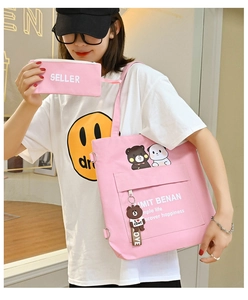 Pink canvas tote bag with cartoon bear pattern and matching small pouch for students