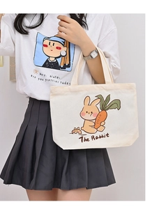 Detail of canvas tote bag featuring cute cartoon rabbit illustration and thick fabric texture