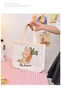 Detail of cute rabbit print on beige canvas tote bag with comfortable double handles