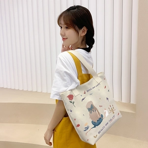 Canvas tote bag with cute cartoon illustration and shoulder strap for daily casual use