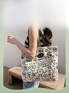 Detail view of durable canvas tote bag featuring cute black hand-drawn food illustrations