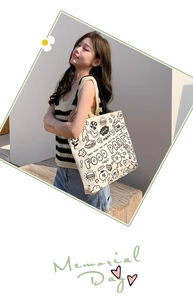 Detail of canvas tote bag showing black doodle art and food party illustrations