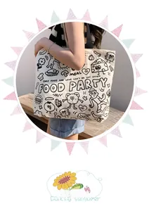 Detail of canvas tote bag with food party cartoons and printed text on a casual model