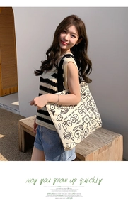 Detail of canvas tote bag with Food Party cartoon print and a casual summer outfit