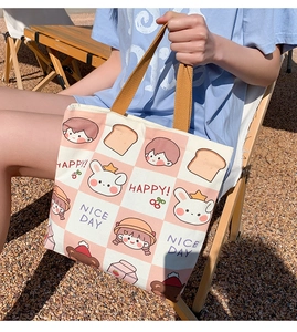 Outdoor shot of a cute pink plaid canvas tote bag with cartoon illustrations and orange handles