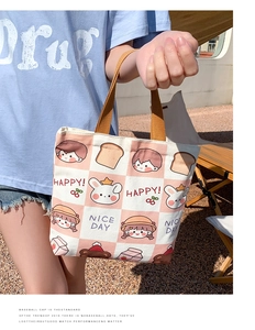 Detail view of pink checkerboard canvas tote bag with cute cartoon illustrations