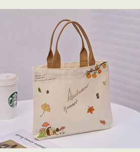 Close-up of cream canvas tote bag with autumn hedgehog and mushroom illustrations