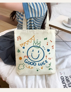 Casual canvas tote bag with cute smiley face graphic, perfect for daily use and shopping.