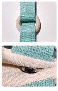 Detail of mint green canvas strap with smooth wooden ring and silver magnetic clasp closure