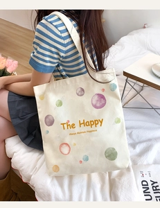 Canvas tote bag detail view featuring watercolor planet print and spacious daily carrying design.