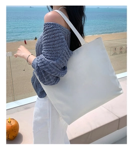 Minimalist white large-capacity canvas tote bag shown from a side view in an outdoor setting