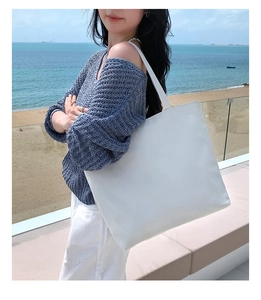 Minimalist white large-capacity canvas tote bag shown on shoulder for daily commute