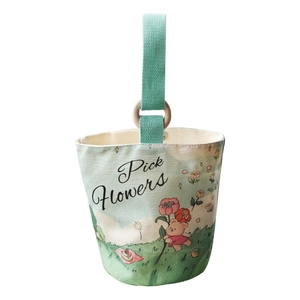 Floral canvas bucket bag with bear print, mint green handle and wooden ring detail