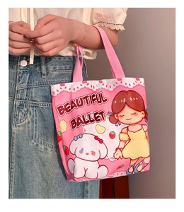 Detail of pink canvas tote bag featuring cute cartoon girl print and woven handles